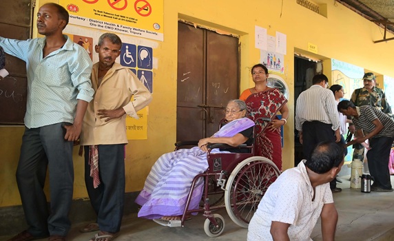 A visually challenged elderly lady is seen in a queue to cast her vote for the second phase of Lok Sabha elections in Teliamura. PIC- Abhisek